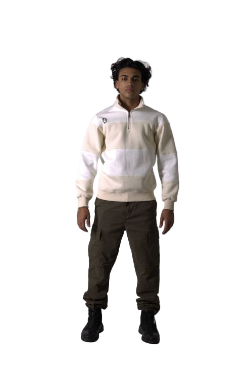 Person wearing a white jacket and dark pants on a plain background