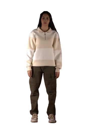 Person wearing a white sweatshirt and dark pants standing on a brown leather couch.