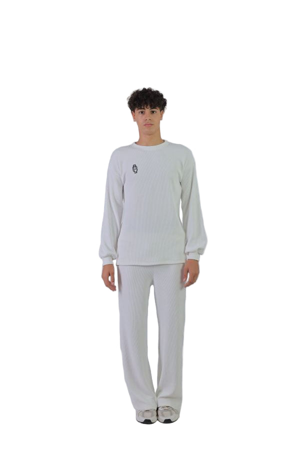 Person wearing a white outfit on a white background