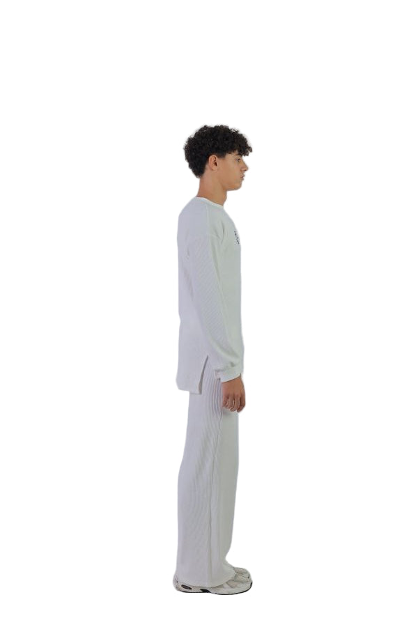 Person wearing a white outfit on a white background
