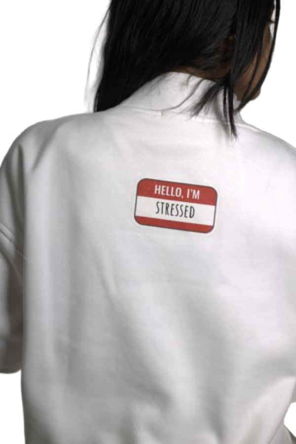 White shirt with a red and white label on the chest