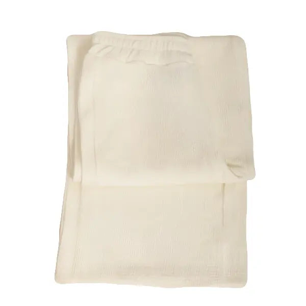 Folded cream-colored towel on a light gray background