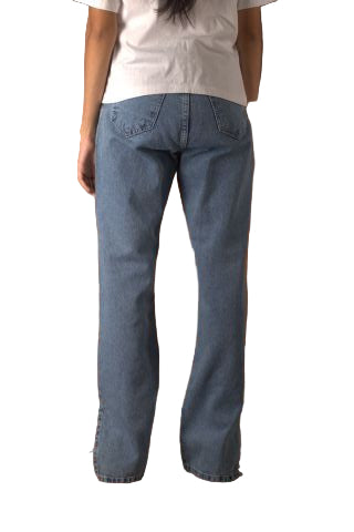 Person wearing blue jeans standing next to a brown leather chair.