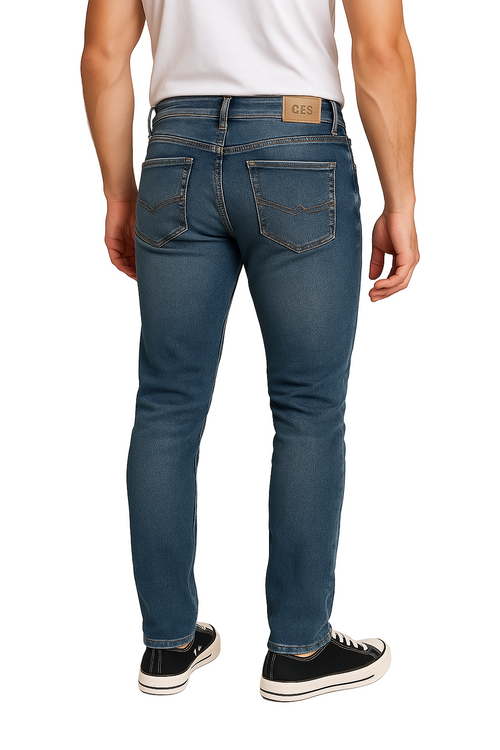 Person wearing blue jeans and a white shirt on a plain background